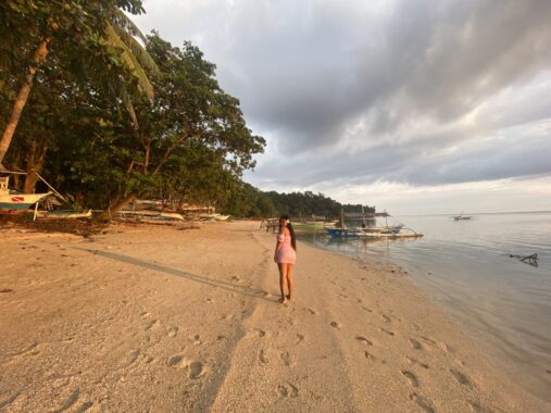 Easy Diving Resort in Sipalay - Beautiful Filipina lady walking along the private beach.